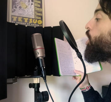 João recording a song in his home studio
