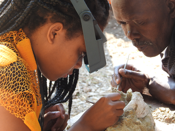 Technician Pepson Makanela from the University of the Witwatersrand in South Africa providing training in fossil preparation in 2019 to Açucena Nhantumbo, a student from University Eduardo Mondlane, Maputo