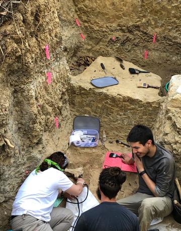 Susana Carvalho, João Coelho and Thomas Püschel excavating Miocene fossils in Gorongosa National Park during the 2019 field season
